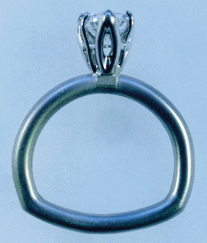 Side view of diamond engagement ring in platinum with tulip setting.
