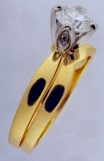Side-view of 18kt gold & diamond engagement ring with wedding band.